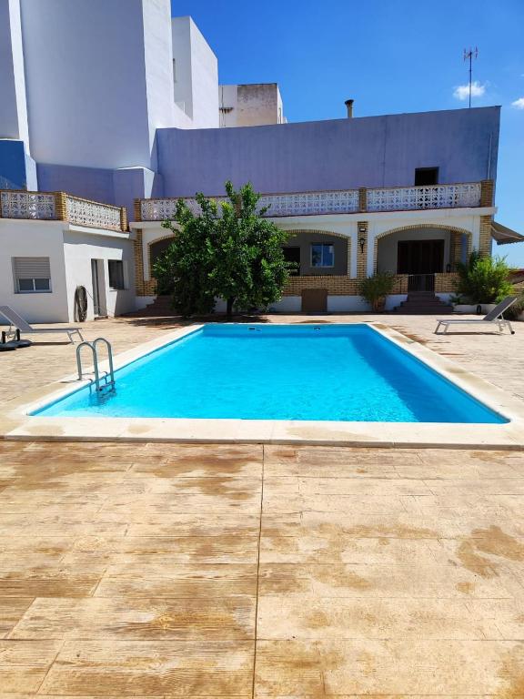 a large swimming pool in front of a building at El Recreo, private Pool & Bbq in Godelleta
