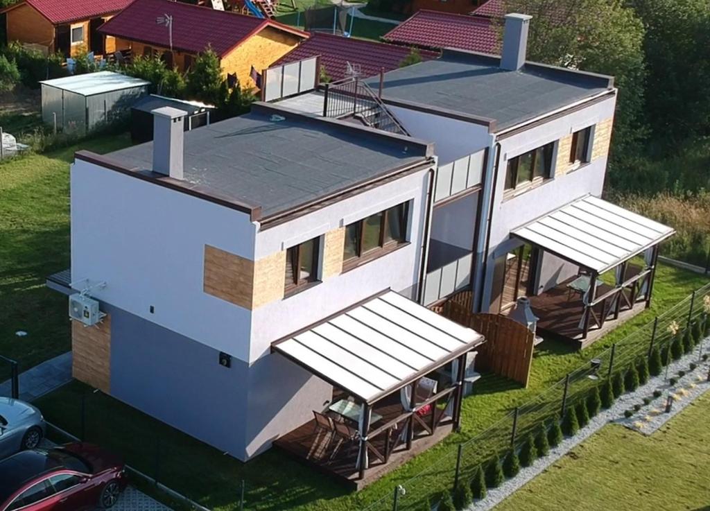 an aerial view of a house on the water at Lavanda Apartamenty in Chłopy