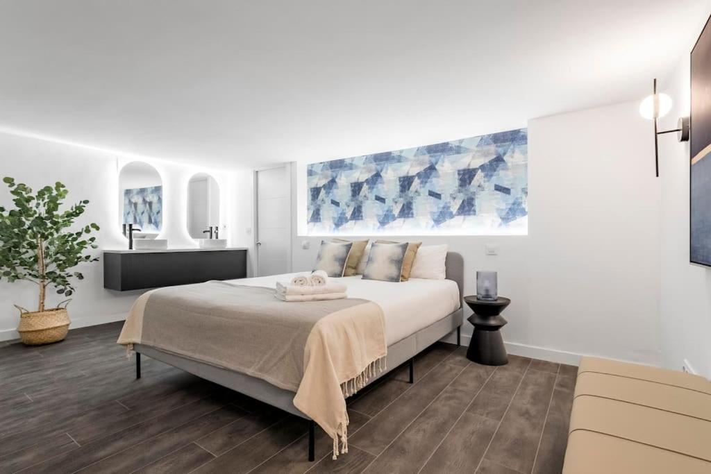 a white bedroom with a large bed and a sink at Beautiful and cosy flat La Latina-Rastro-IZQ in Madrid