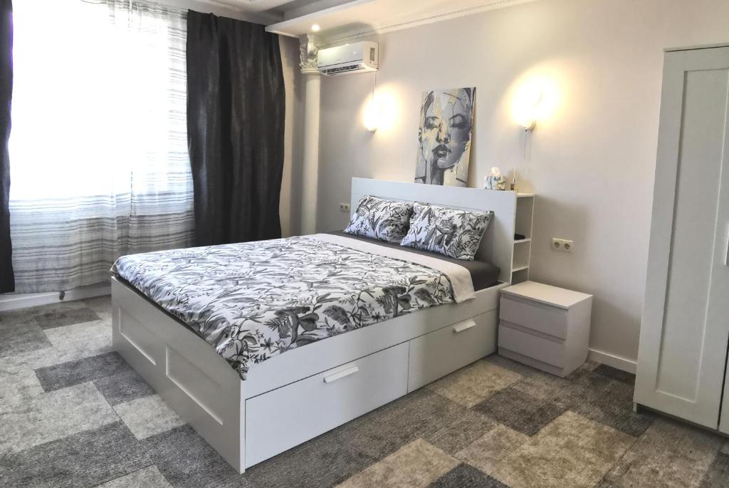 Schlafzimmer mit einem weißen Bett mit Kopfteil in der Unterkunft Guest House in Mykolaiv in Mykolajiw