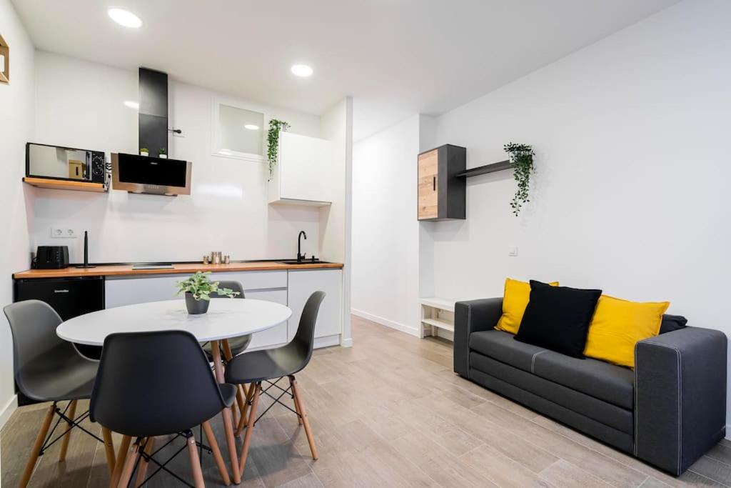 a living room with a couch and a table and chairs at Nice apartment in the center of Madrid-S-EL-VERDE in Madrid