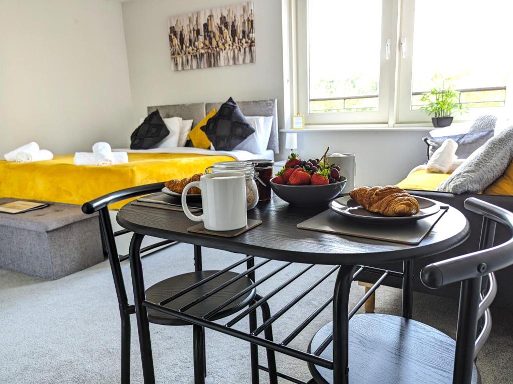 a table with a plate of food on it in a living room at Studio for Professionals Trades Relocators in Cardiff