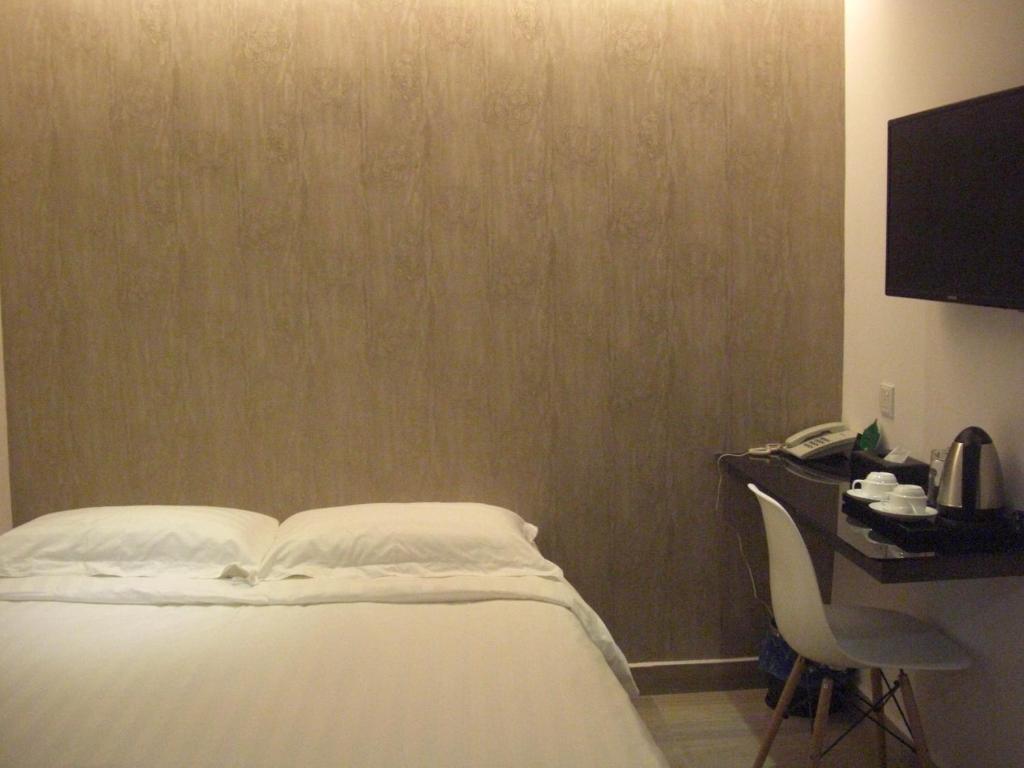 Postel nebo postele na pokoji v ubytování Marvelot Hotel