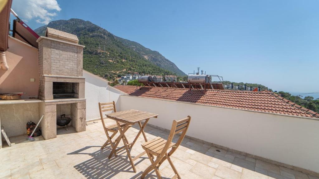 a table and chairs on a patio with a view of a mountain at Villa w Terrace 5 min to Lycian Way in Fethiye in Fethiye