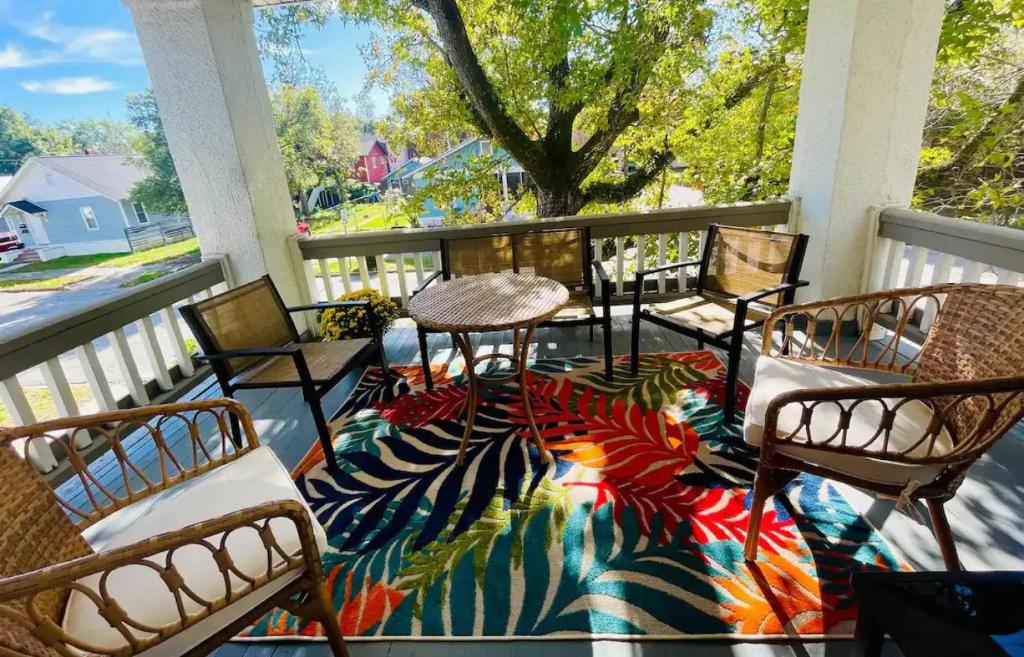 a patio with chairs and a table on a rug at Luxury Home near South Historic District in Coffeyville