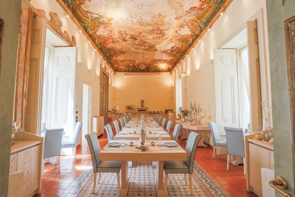 a long dining room with a long table and chairs at Maison Tofani in Sorrento