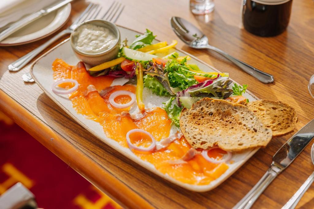 a plate of food with a salad and a sandwich at Muthu Alexandra Hotel in Oban