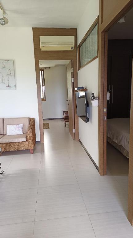 a hallway with a room with a bed and a television at La View 麗晨 Homestay in Manzhou