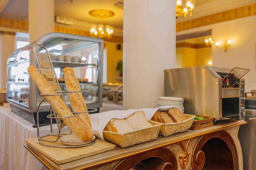 a table with bread and baskets of bread at Muthu Alexandra Hotel in Oban