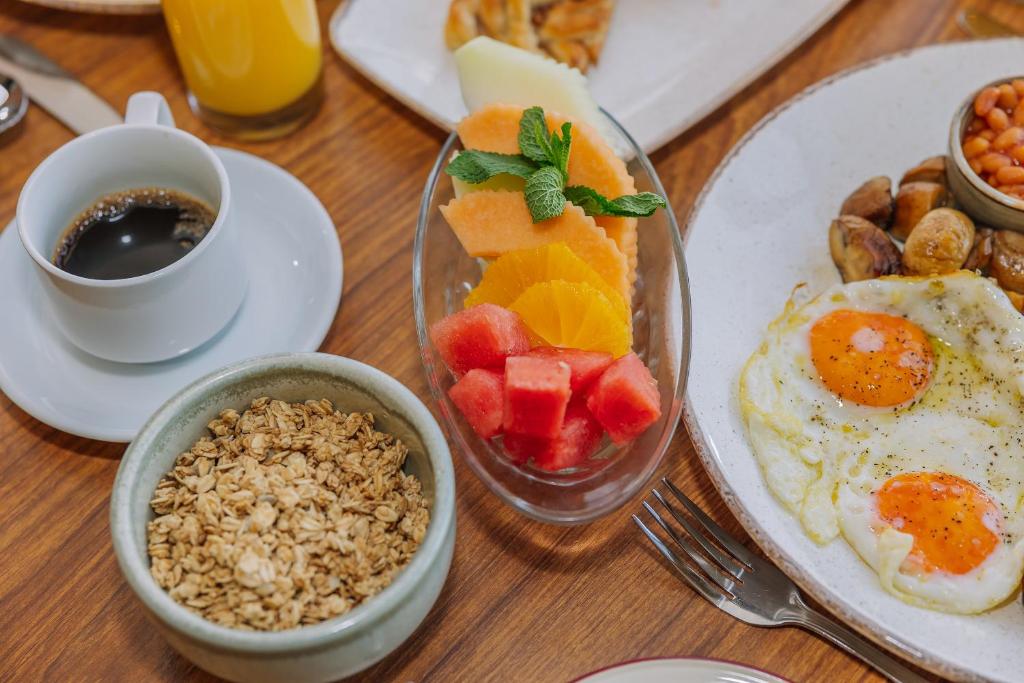 a table with a plate of food with eggs fruit and nuts at Muthu Alexandra Hotel in Oban
