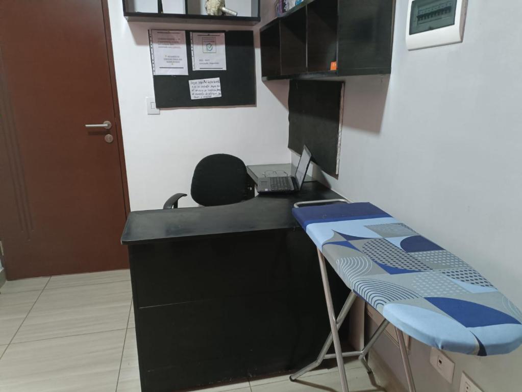 an office with a desk with a phone and a stool at Apartment Matisse in Cochabamba
