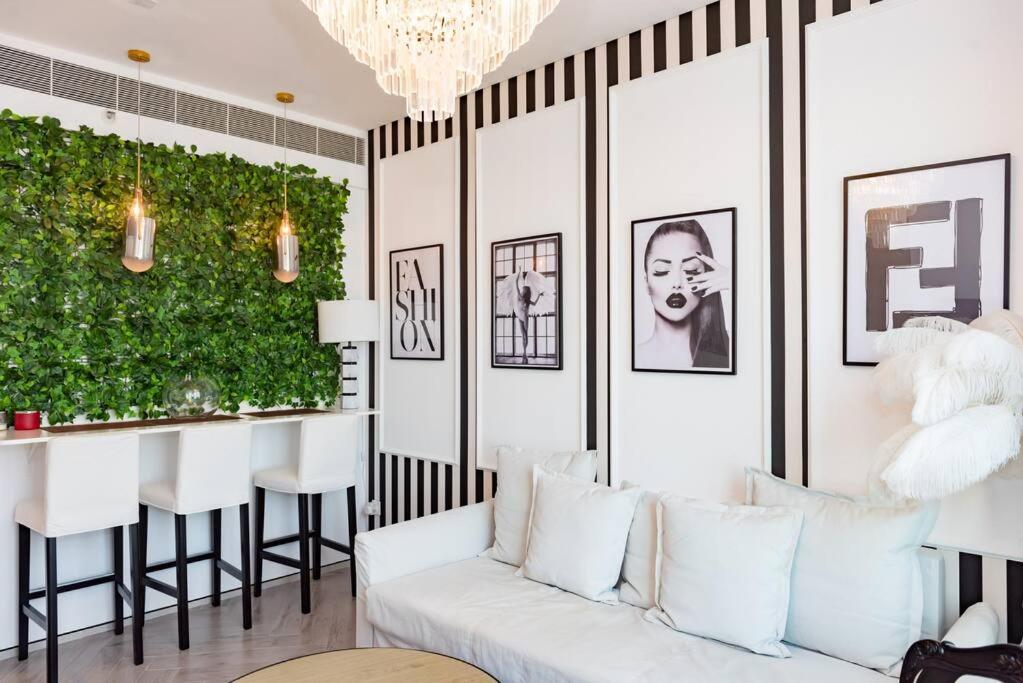 a living room with a white couch and a green wall at Luxury1BR at The Address Residences in JBR in Dubai