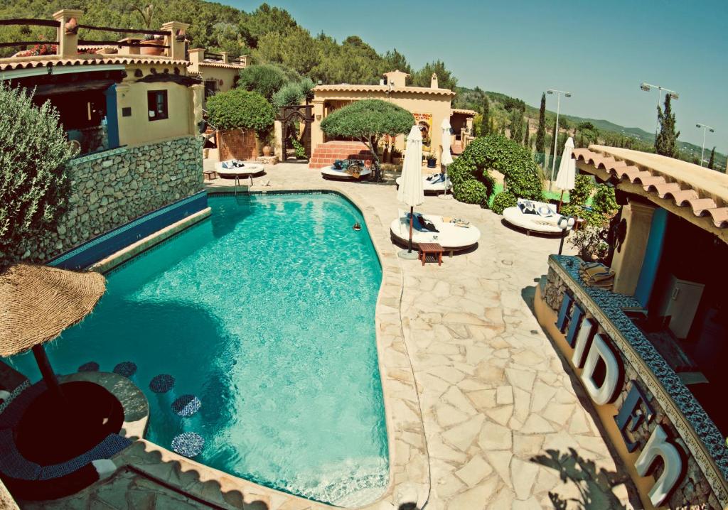 a swimming pool in the middle of a house at Pikes Ibiza in San Antonio