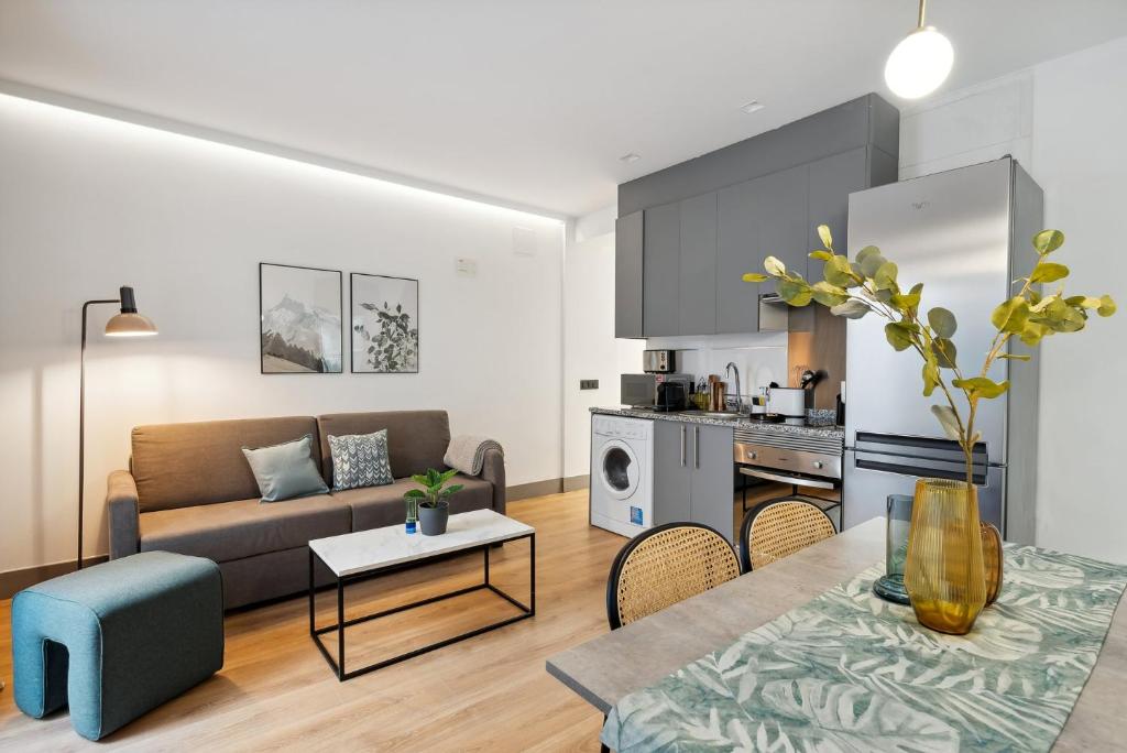 a living room with a couch and a table at Limehome Madrid Calle de Santa Ana - estancia temporal in Madrid