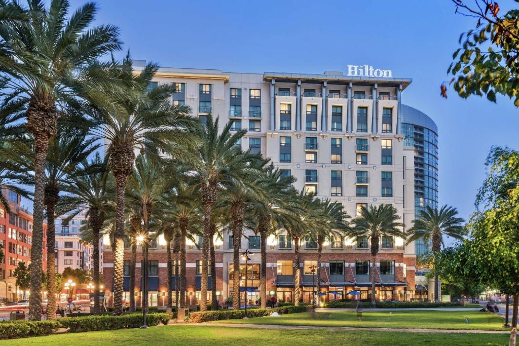 a row of palm trees in front of a hotel at Hilton San Diego Gaslamp Quarter in San Diego