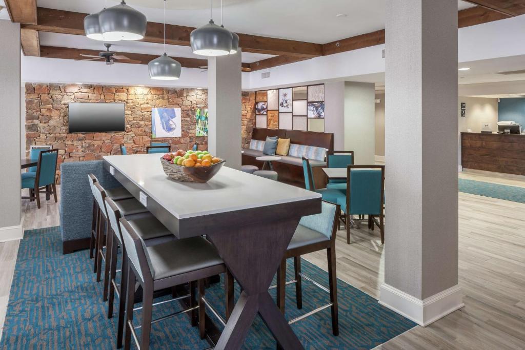 a dining room and lobby with a table and chairs at Hampton Inn Austin NW near The Domain in Austin