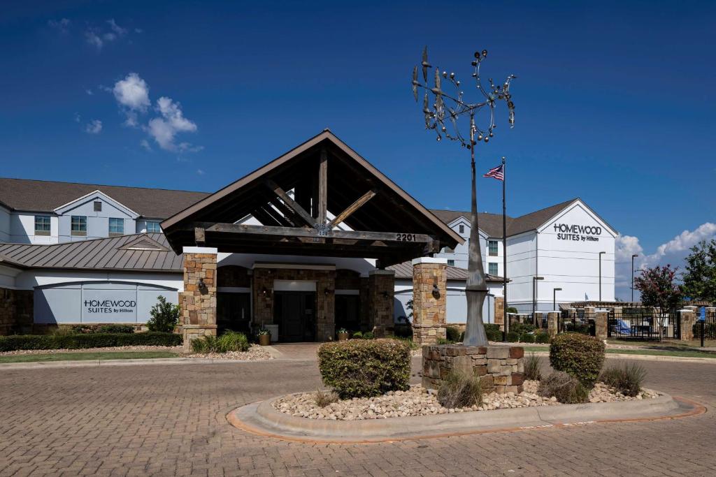 a building with a clock in front of it at Homewood Suites by Hilton Austin/Round Rock in Round Rock