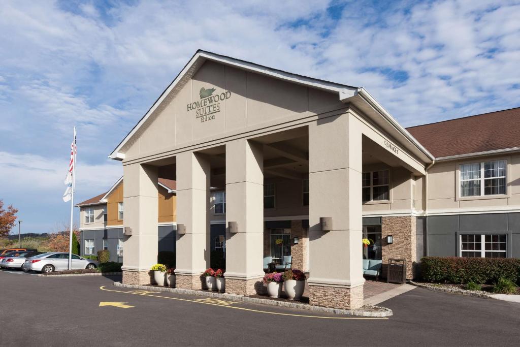 a front view of a hotel with a parking lot at Homewood Suites by Hilton Mahwah in Mahwah