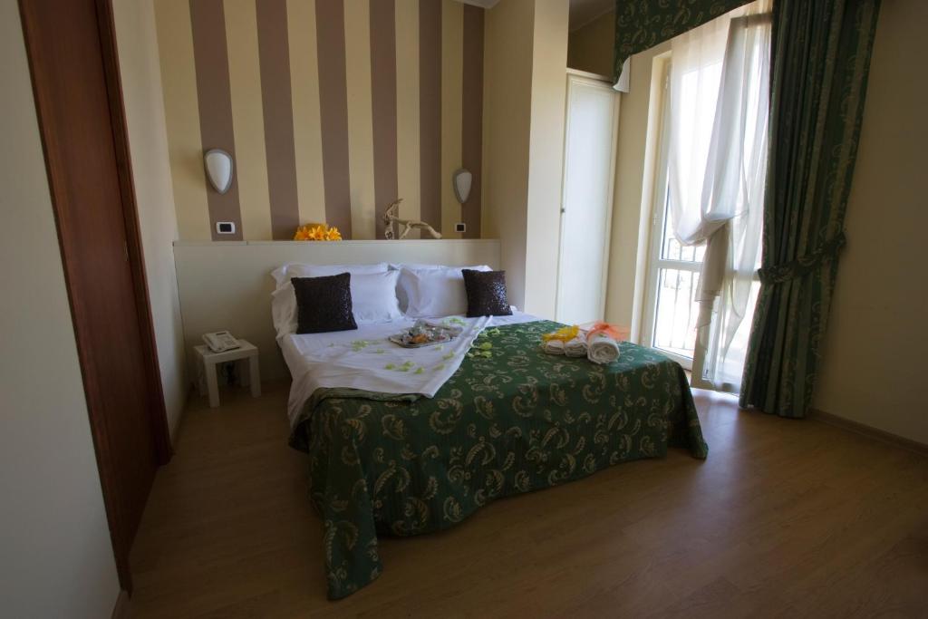 Łóżko lub łóżka w pokoju w obiekcie Hotel La Palazzina