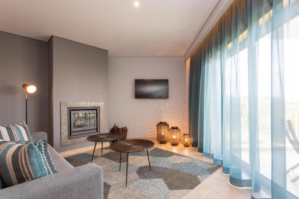 a living room with a couch and a fireplace at Placid Village in Carvoeiro