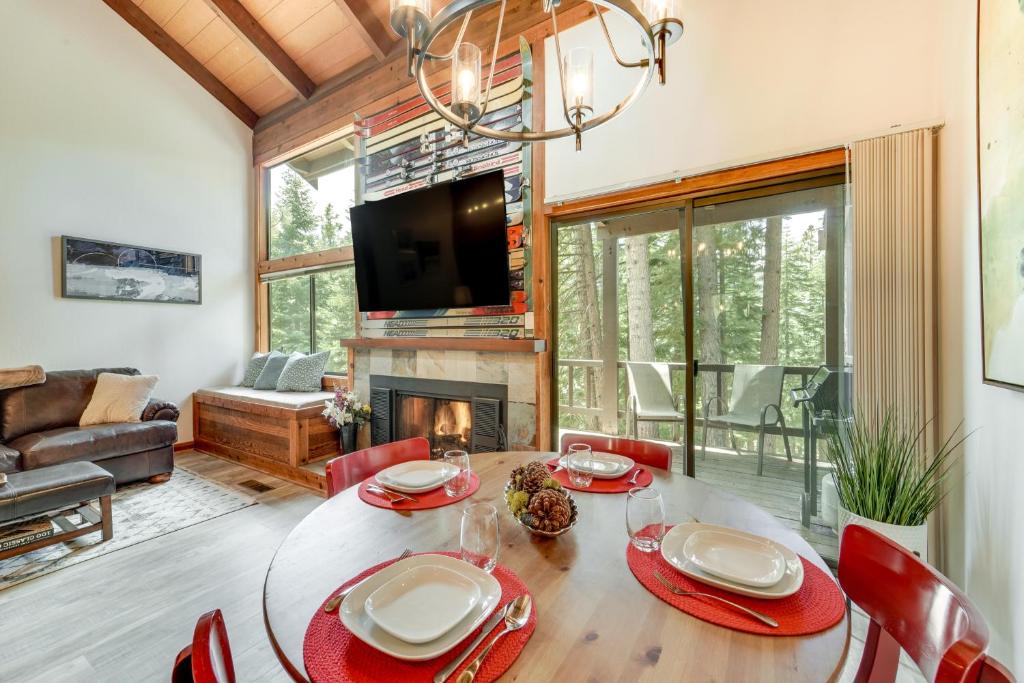 a dining room with a table and a fireplace at 1 Mi to Northstar Village Pet-Friendly Condo! in Truckee