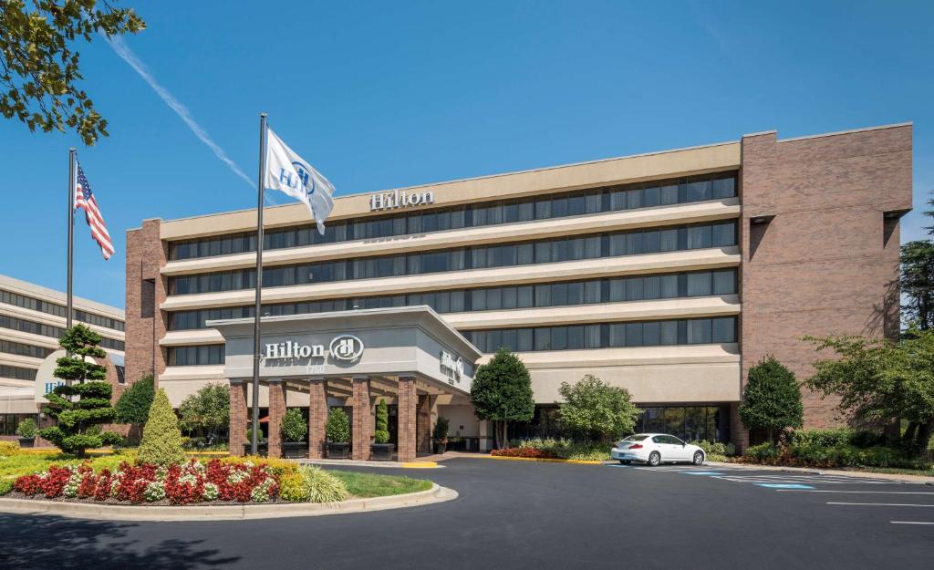 ein Bürogebäude mit einem davor geparkt in der Unterkunft Hilton Washington DC/Rockville Hotel & Executive Meeting Center in Rockville