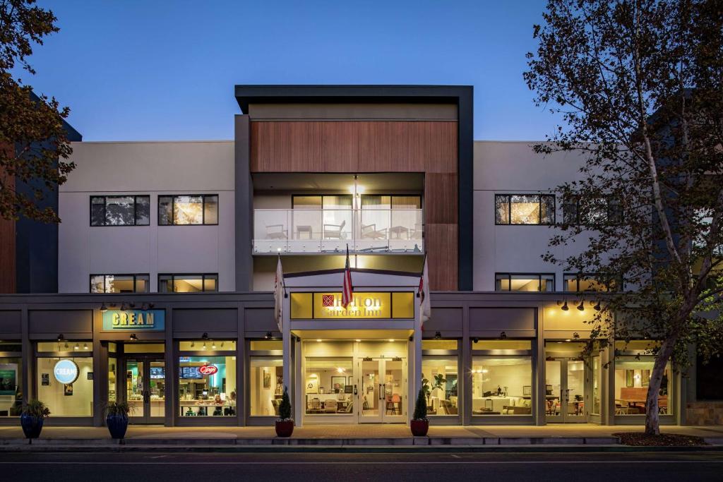 a store front of a building at night at Hilton Garden Inn Davis Downtown in Davis