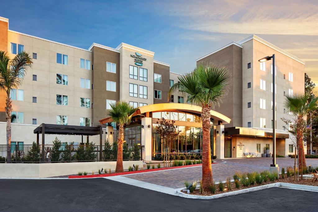 a large building with palm trees in front of it at Homewood Suites by Hilton San Diego Mission Valley/Zoo in San Diego