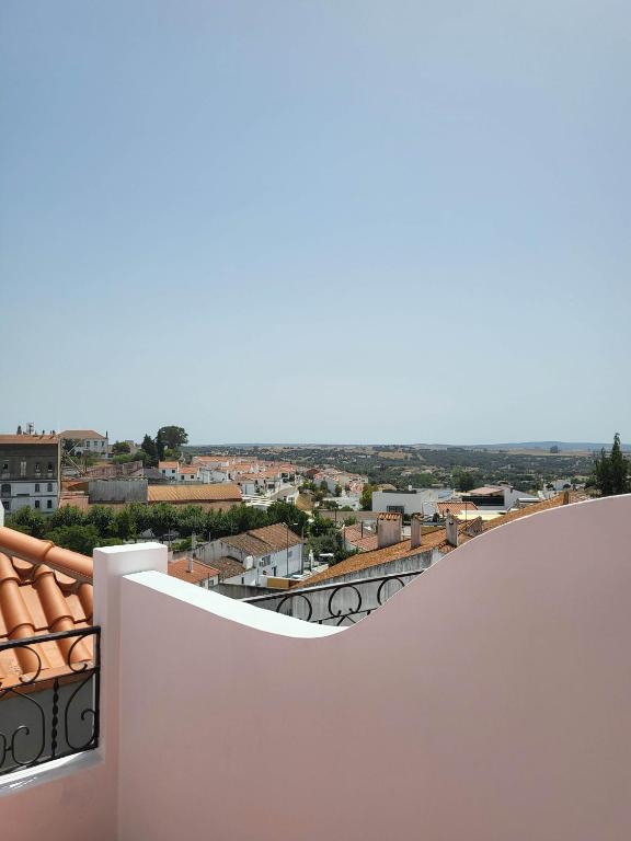 a balcony with a view of a city at Solar de Arrayollos by PURUS in Arraiolos