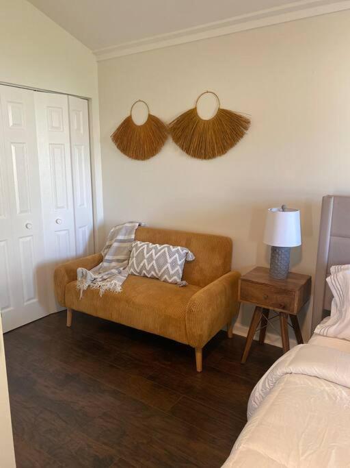 a living room with a couch and a bed at Boho Hideway! in New Albany