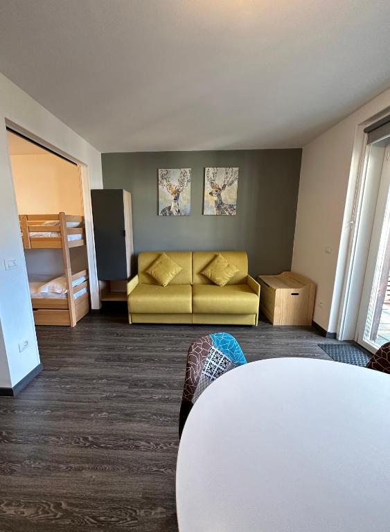a living room with a couch and a table at Stay in Cervinia Deluxe Apartment in Breuil-Cervinia
