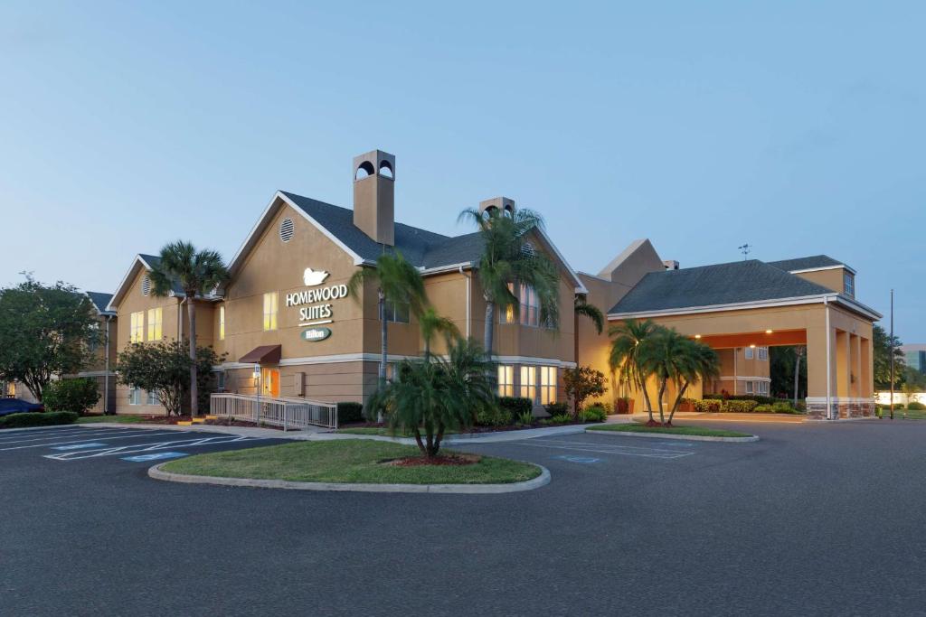 a building with palm trees in a parking lot at Homewood Suites by Hilton St. Petersburg Clearwater in Clearwater