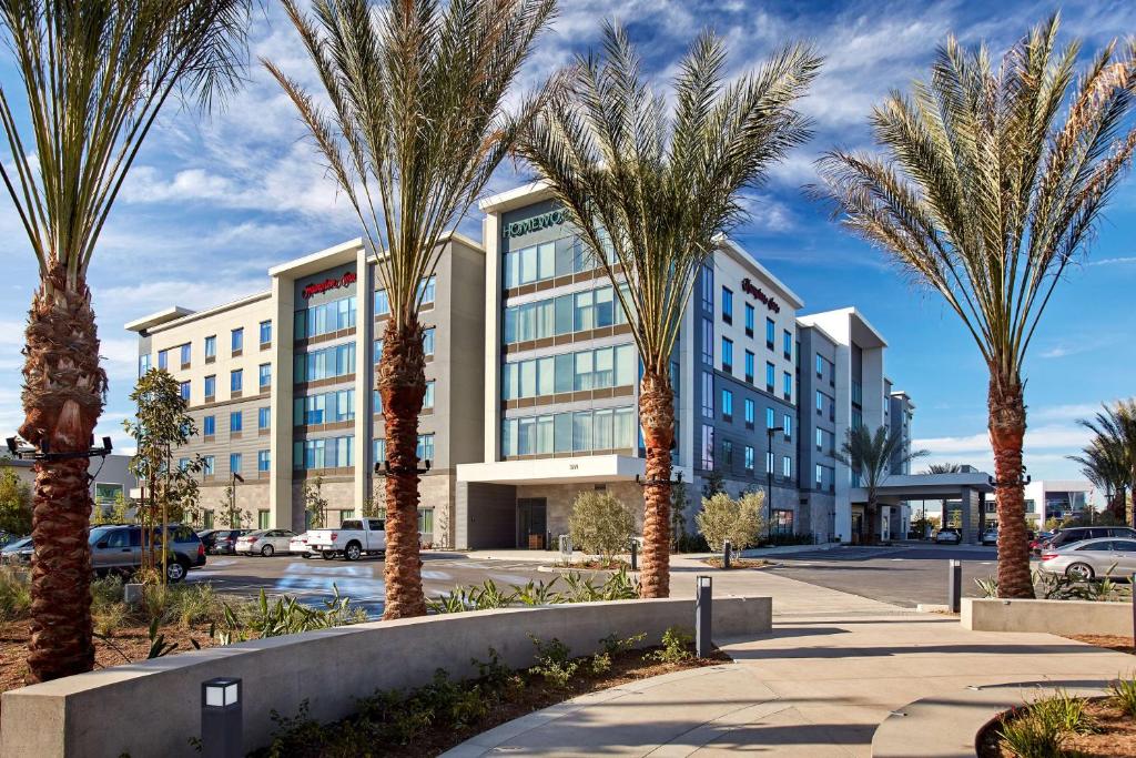 a group of palm trees in front of a building at Homewood Suites By Hilton Long Beach Airport in Long Beach