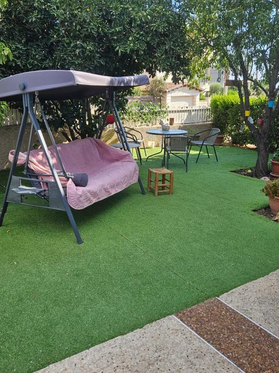 a swing on the grass in a backyard at LTD Hadas Garden apartment in Tiberias