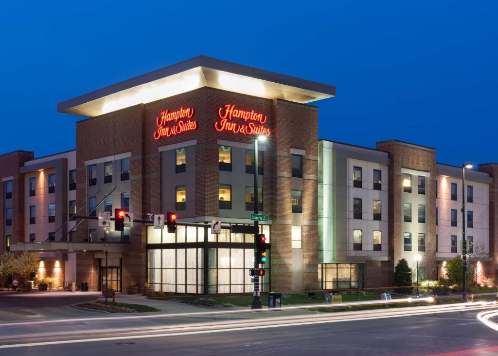 a building with a sign on it on a street at Hampton Inn & Suites Omaha-Downtown in Omaha