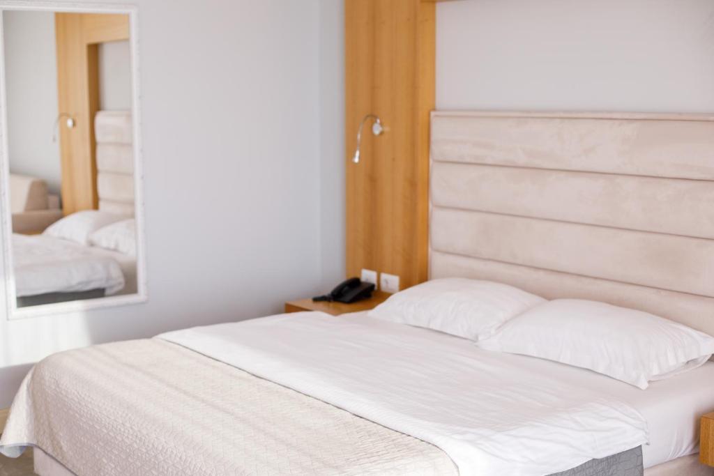 Postel nebo postele na pokoji v ubytování Hotel GRINT
