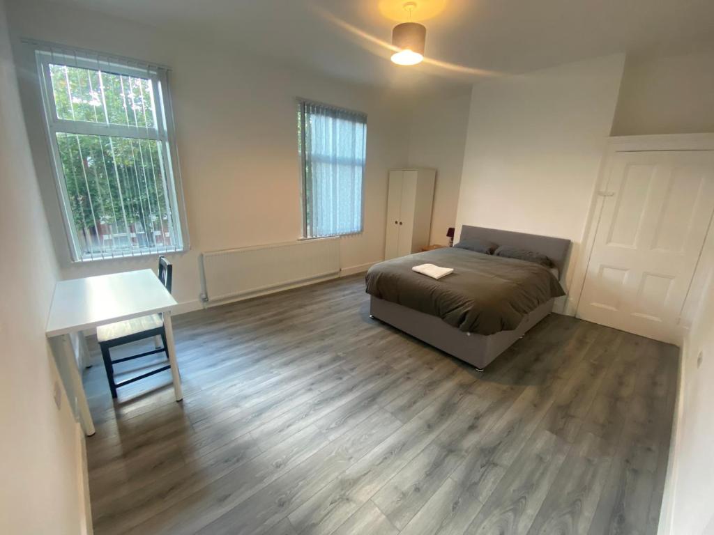a bedroom with a bed and a desk in it at Luxury Fully Furnished Bedroom in Leicester