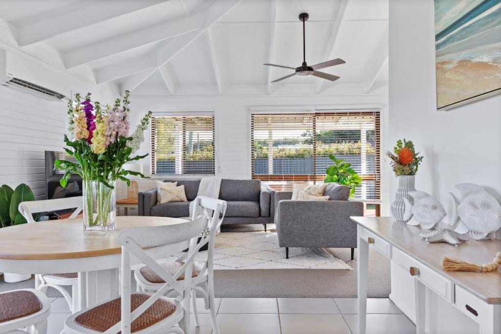 a living room with a table and chairs at Pet friendly family escape in Coolum Beach