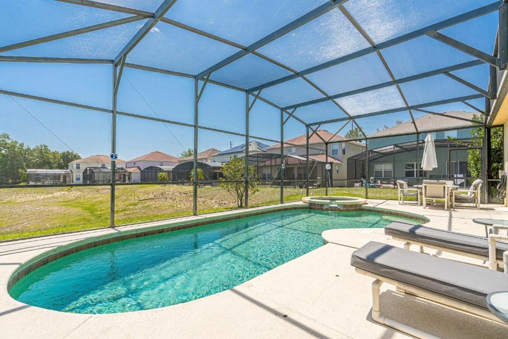 a large swimming pool with a glass roof at Mickey's Holiday Home in Davenport