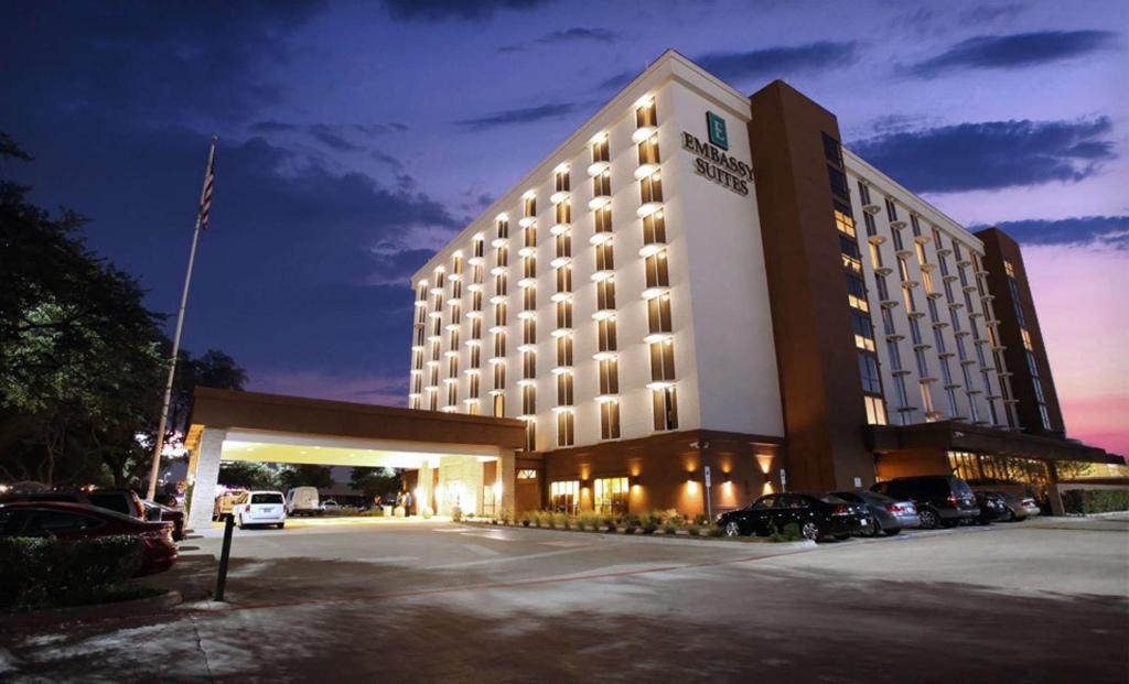 a hotel building with a parking lot in front of it at Embassy Suites by Hilton Dallas Market Center in Dallas