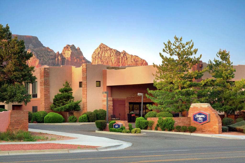 a building with a mountain in the background at Hampton Inn Sedona in Sedona