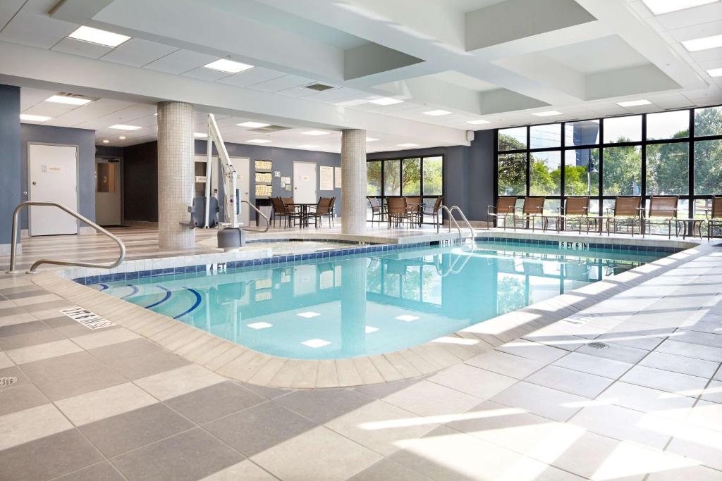 a large swimming pool in a hotel lobby at Embassy Suites by Hilton Atlanta Galleria in Atlanta