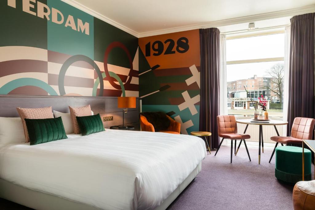 a hotel room with a bed and a table at Apollo Hotel Amsterdam, a Tribute Portfolio Hotel in Amsterdam