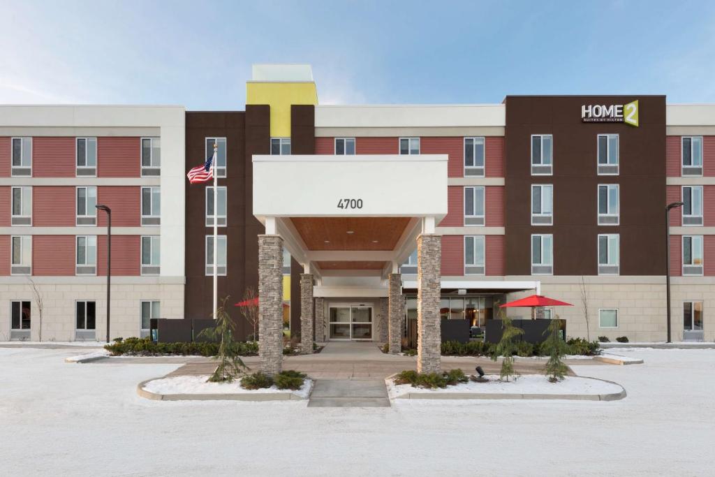 a front view of a hotel with a building at Home2 Suites by Hilton Anchorage/Midtown in Anchorage