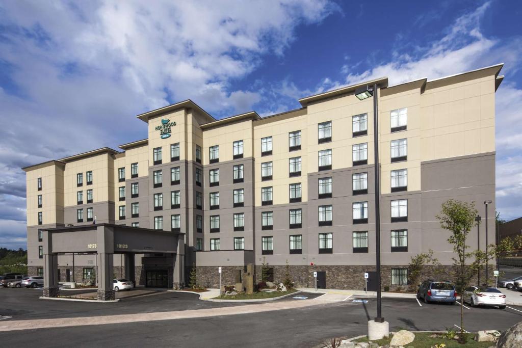 a large tan building with a parking lot at Homewood Suites by Hilton Seattle/Lynnwood in Lynnwood