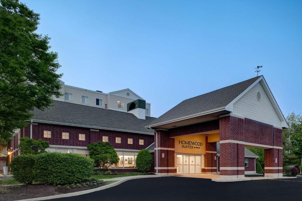 a large brick building with a church at Homewood Suites Lansdale in Lansdale