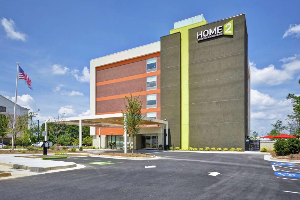 a building with a home sign in a parking lot at Home2 Suites By Hilton Atlanta Lithia Springs in Lithia Springs