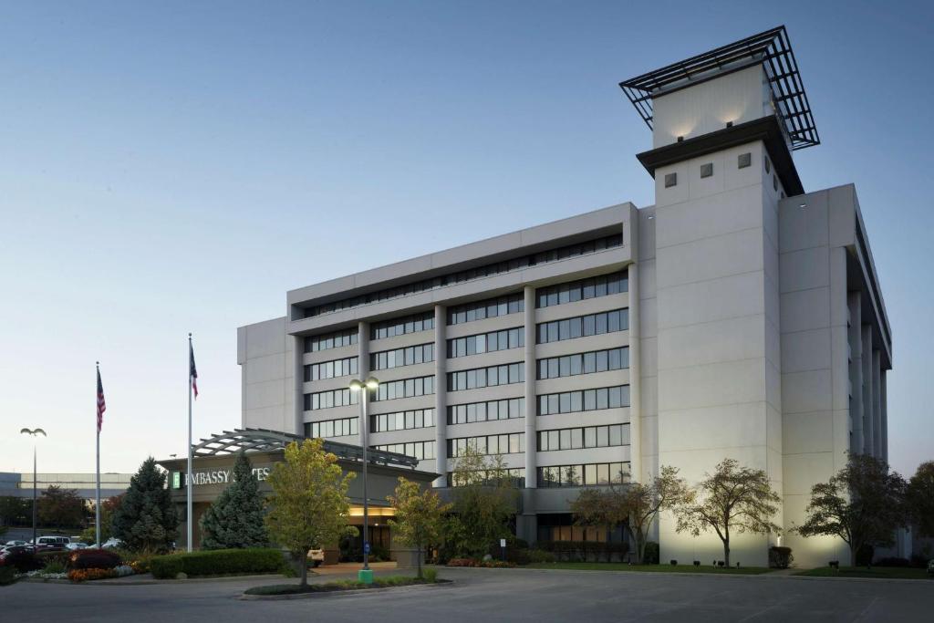 a large white building with a clock tower at Embassy Suites by Hilton Columbus in Columbus