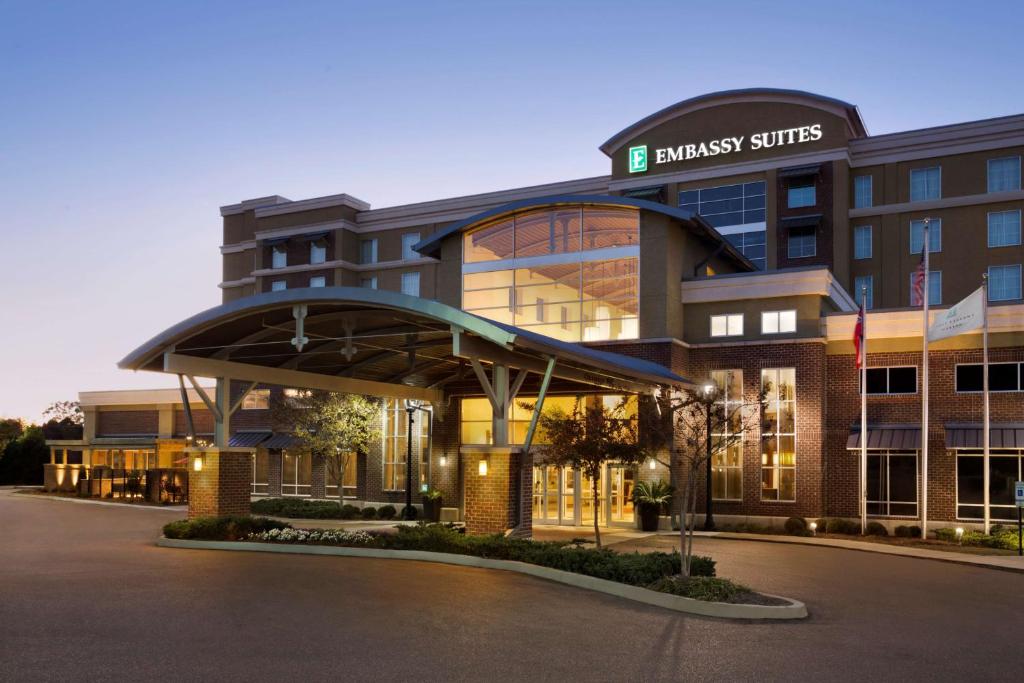 a building with a parking lot in front of it at Embassy Suites by Hilton Jackson North Ridgeland in Ridgeland