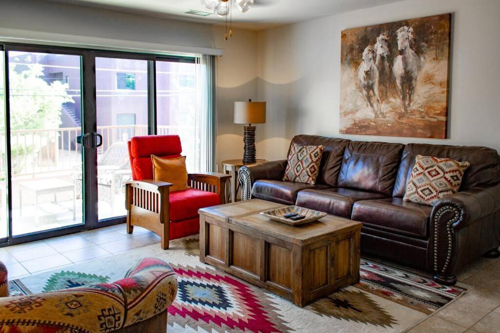 a living room with a leather couch and a coffee table at Cowboys & Angels - Classic Sedona style w/great location in Sedona